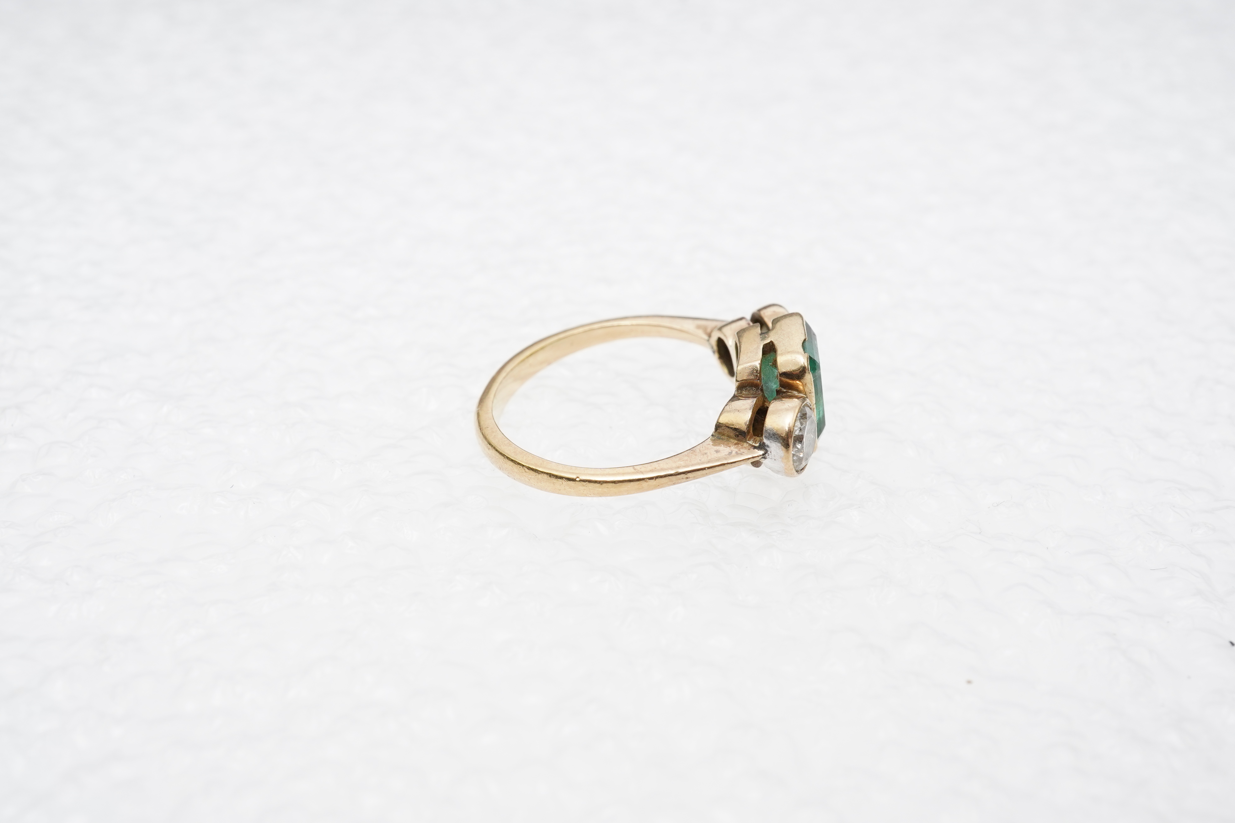An emerald and diamond ring